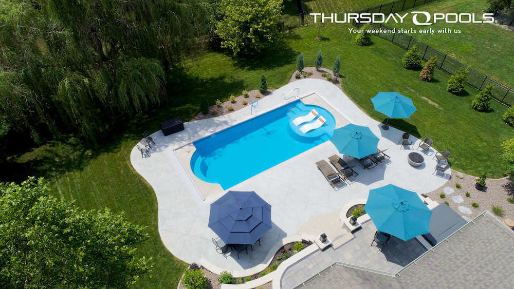 Cathedral LX Thursday Pools Fiberglass Inground Pool in a backyard in Indianapolis Indiana by Jensen's Pools and More