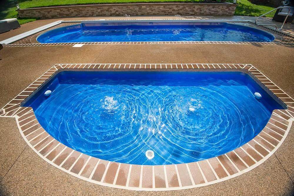 Wet Deck Thursday Pools Fiberglass Inground Pool in a backyard in Indianapolis Indiana by Jensen's Pools and More