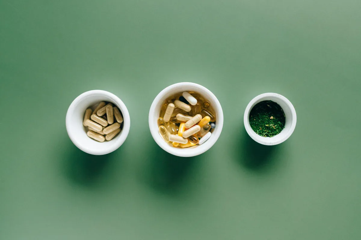 three white bowls filled with vitamins