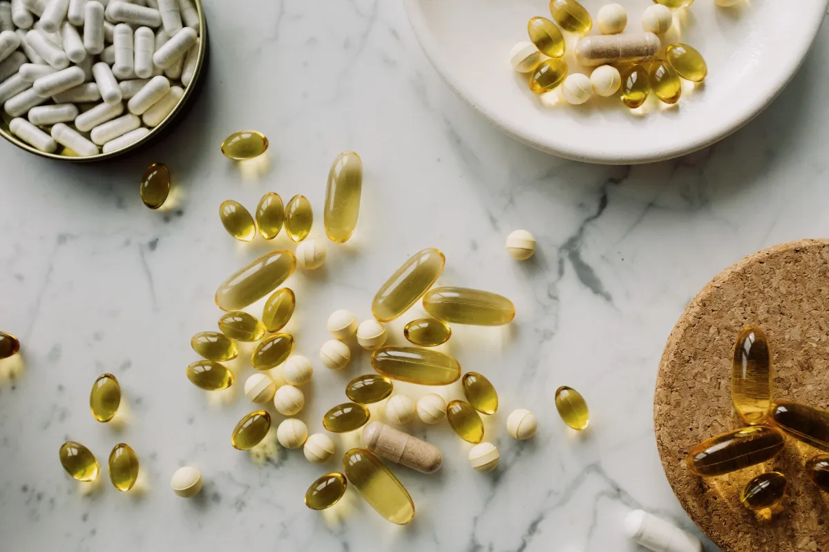 various vitamins spread out on counter in small bowls
