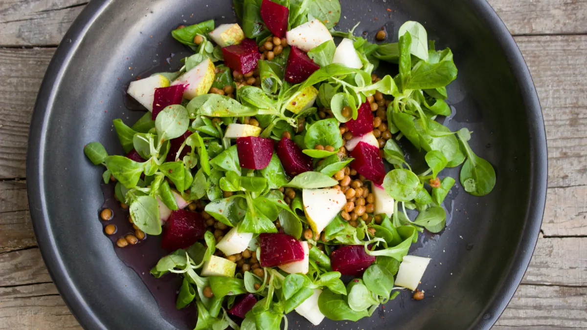 top down view of leafy green salad on plate