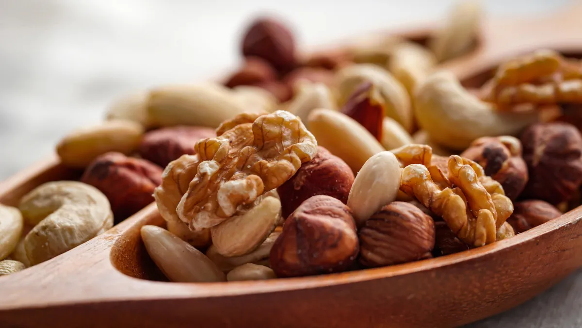 spoon filled with variety of nuts and seeds