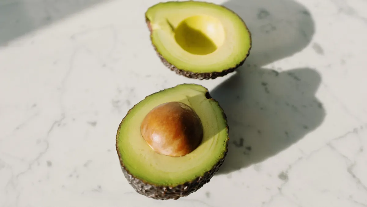 avocado sliced in half on counter