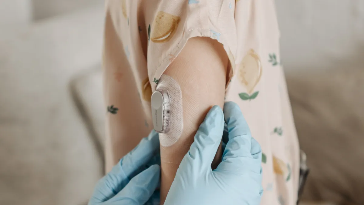 doctor holding child's arm with CGM