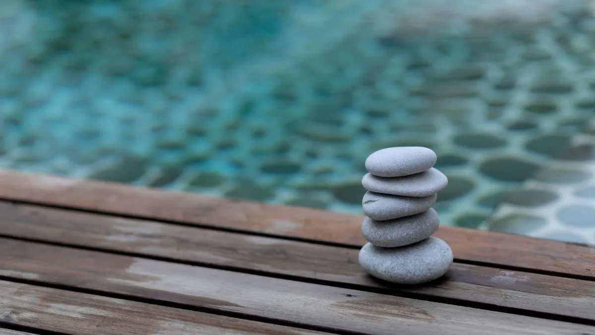 stones stacked on a dock by water