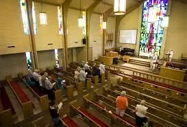 large church sanctuary with small group in attendance