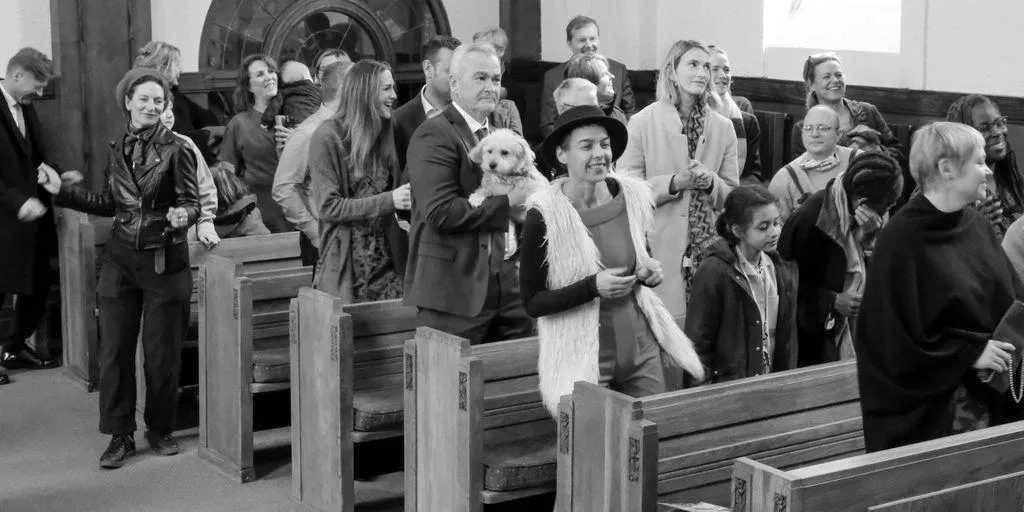 a black and white photo of people in a church