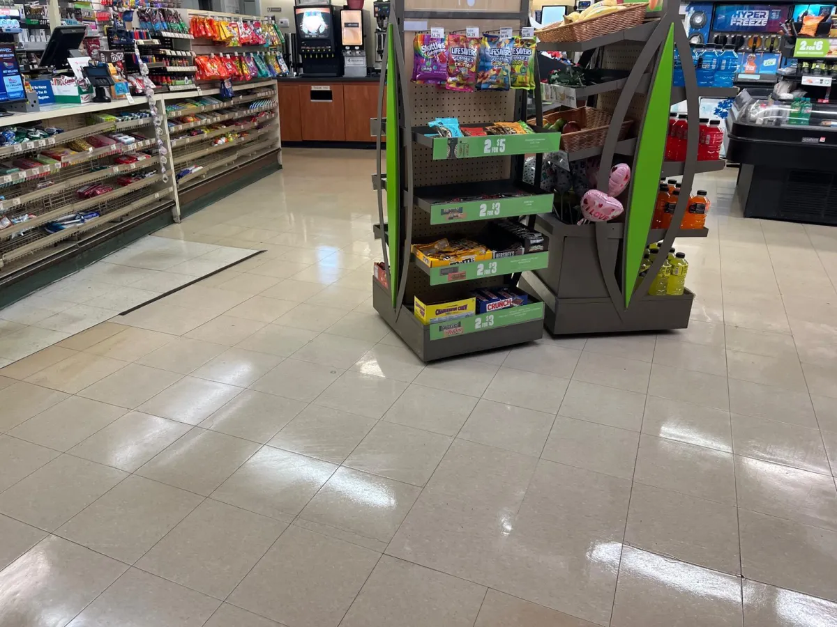 A freshly cleaned, super shiny store floor reflecting light, showcasing the results of professional cleaning.