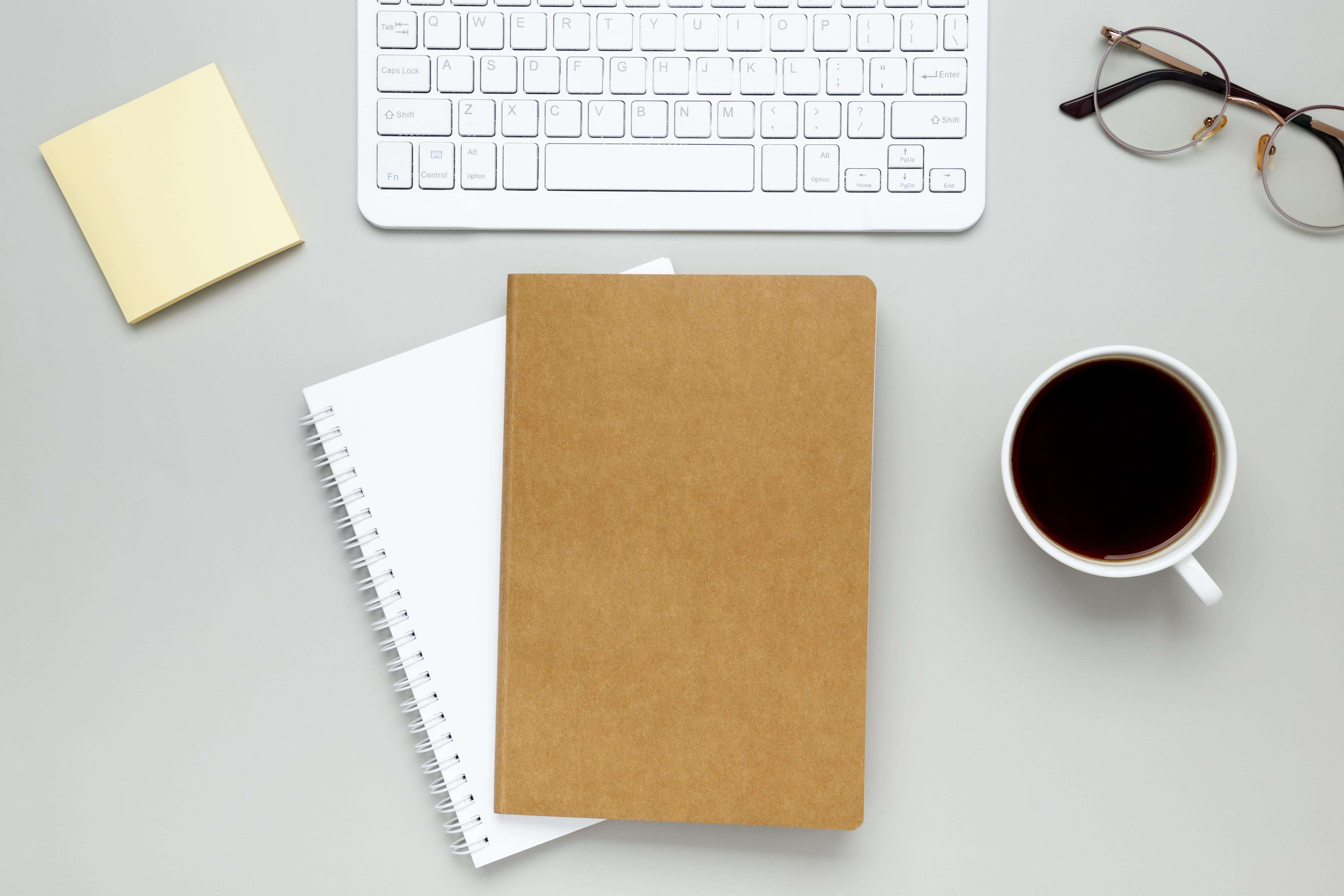 A woman sitting thoughtfully at a clean desk in natural light, symbolizing reflection and mental clarity.