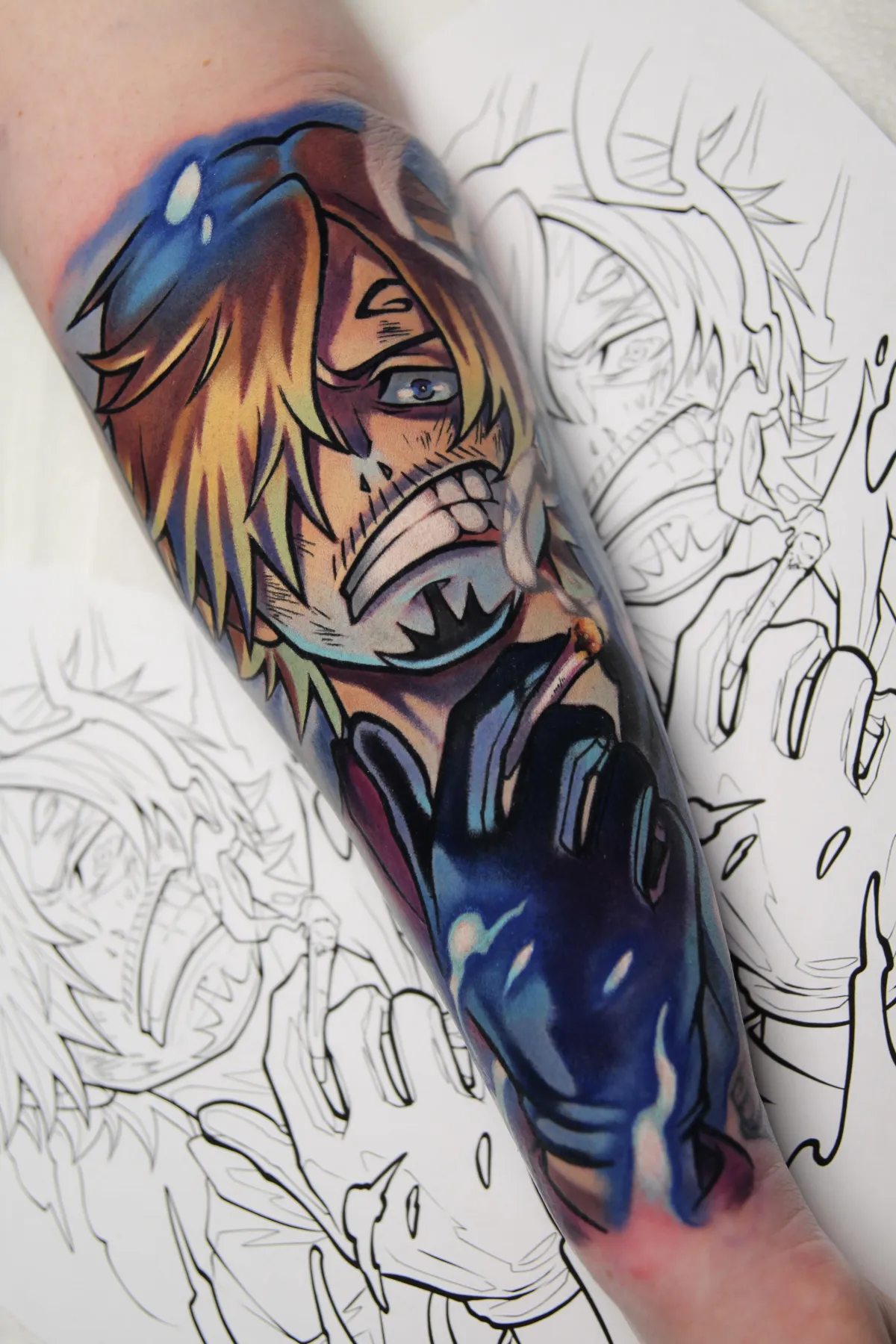 A realistic anime tattoo of Sanji from One Piece, featuring dynamic shading and bold linework to capture his signature suave, but fiery demeanor. Tattooed by Orlando anime tattoo artist Ren Behan at xsadfamx