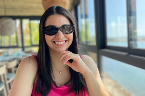 A smiling woman sitting at a restaurant