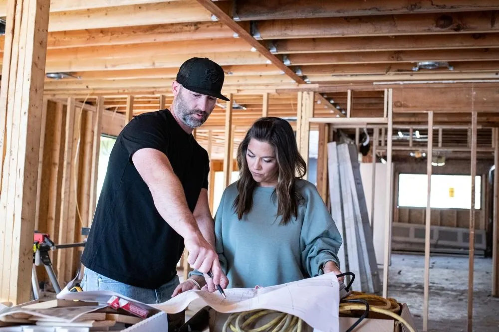 Beau and Julianne looking over a blueprint
