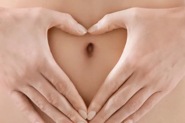 Woman holding her stomach representing gut health