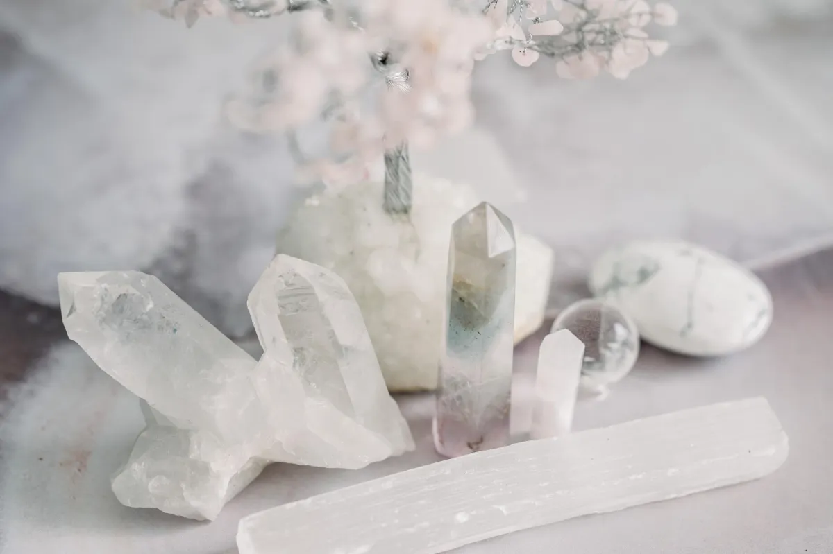 A serene display of clear and translucent crystals on a pastel background.