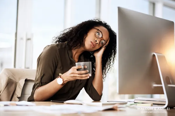 Frustrated Black Women Holding Coffee Mug Looking at Computer