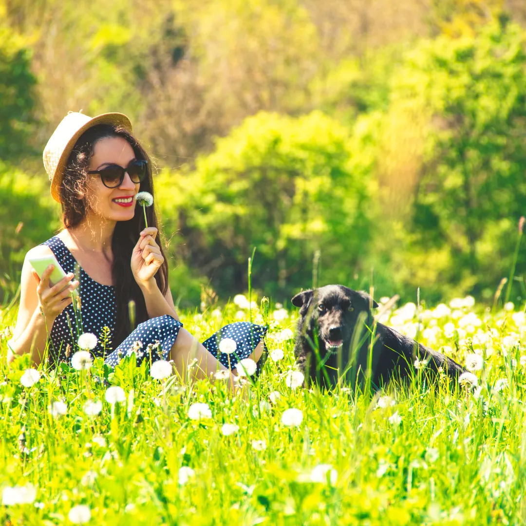 woman with dog in field