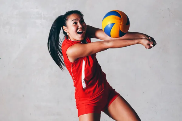 Image of a volleyball player practicing solo drills, such as hitting against a wall or practicing footwork patterns.