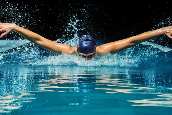 Image of a volleyball player engaging in cross-training activities, such as swimming, cycling, or weightlifting.