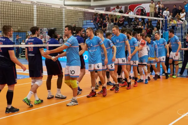 Image of volleyball players shaking hands or showing respect to their opponents and officials.