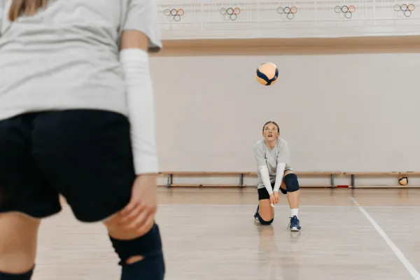 Image of a volleyball player engaging in recovery activities, such as stretching, foam rolling, or taking an ice bath.