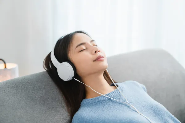 Image of a person listening to relaxing music or playing a musical instrument.