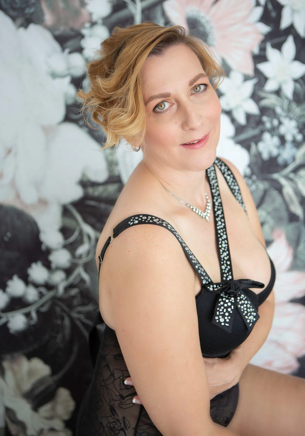 Women in lingerie in front of floral wall