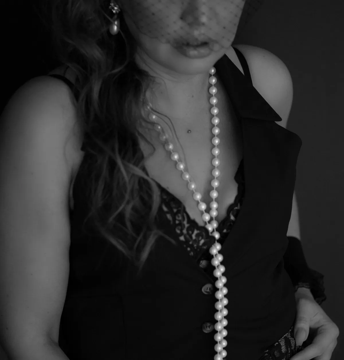 Blakc and white image if women in lingerie with pearls