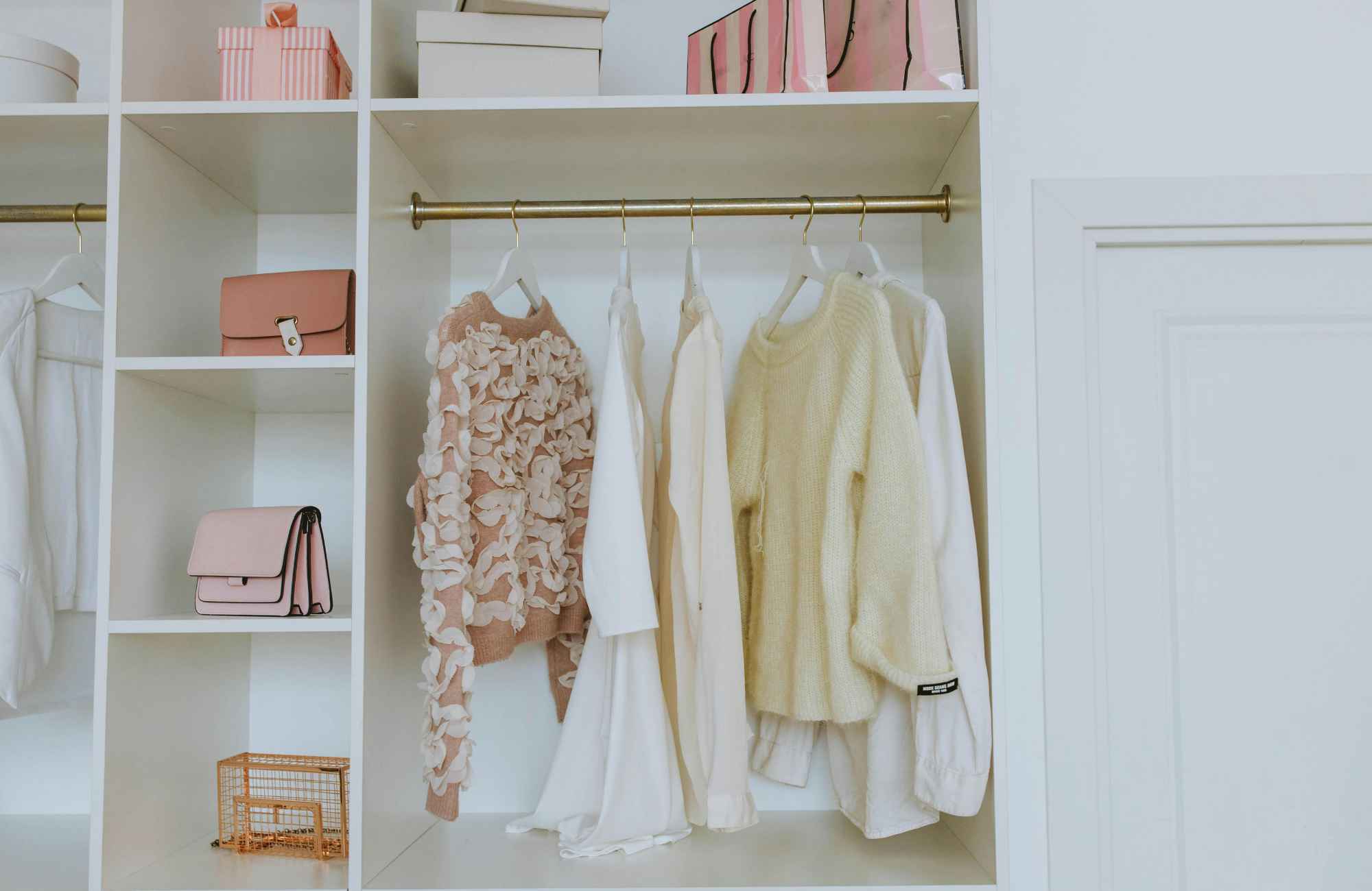 shannon's-organizing-solutions-kingman-az-spring-closet-organization-tips-woman's-closet-with-pastel-clothes-hanging-accessories-on-shelves