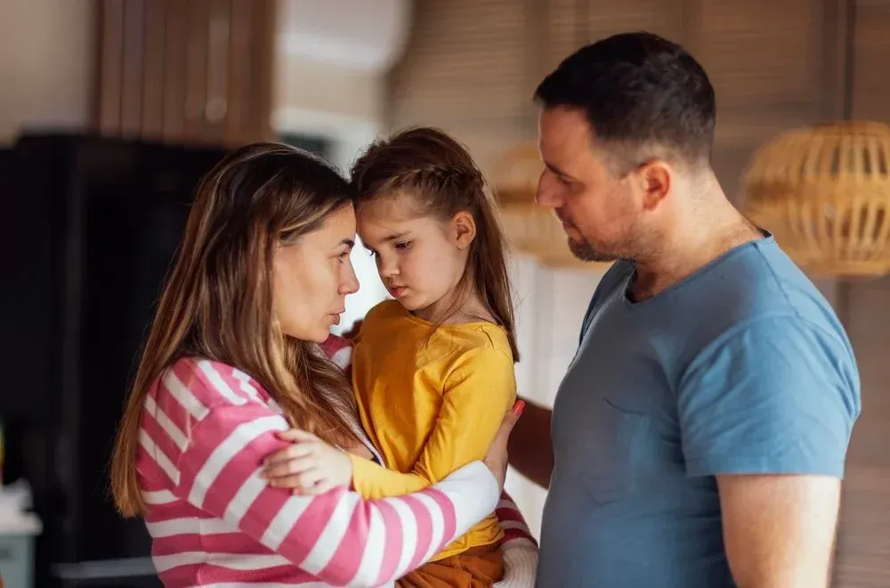 family of 3 talking during the Christmas holidays