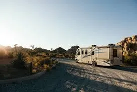 A Class A motorhome parked by a scenic road, symbolizing RV travel and adventure. The blog encourages readers to learn key RV terms to make informed decisions, enhance their buying experience, and get the most out of their RV lifestyle.