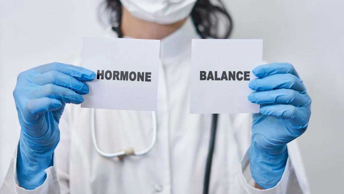 Doctor holding signs that say hormone balance.