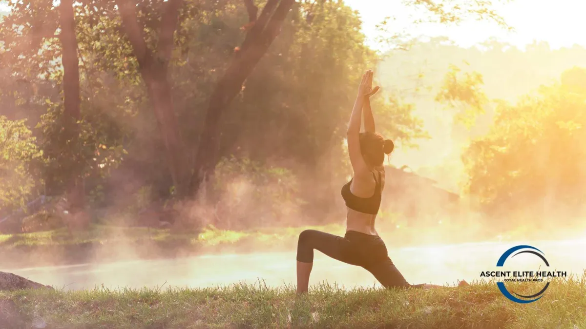 Woman in yoga pose in a dramatically lit photo.