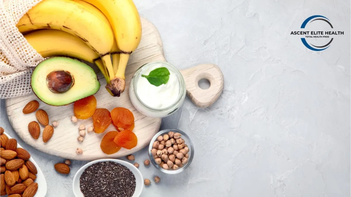 Various fruits on a table and cutting board with Ascent Elite Logo