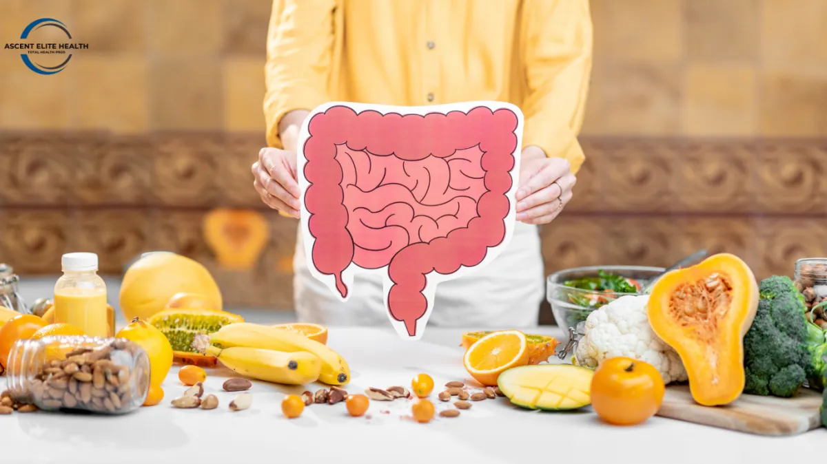 Person holding a picture of a stomach and is surrounded by food