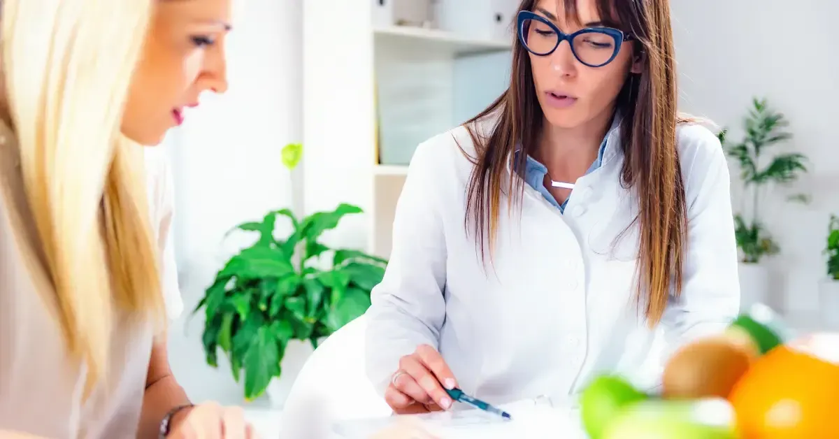 Nutritionist reviewing food sensitivity test results with a patient, discussing hidden food triggers and personalized dietary recommendations in Hurricane, WV.