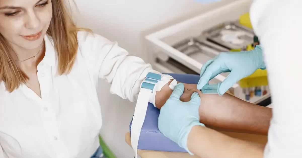 Woman having blood drawn by a healthcare professional, demonstrating the blood testing process commonly used to evaluate hormone imbalances.