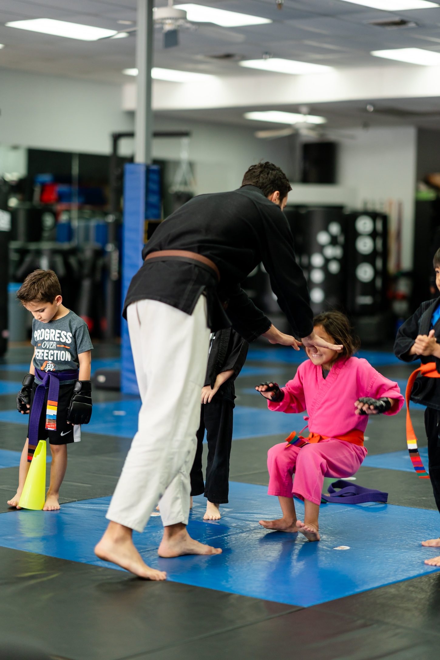 Children and instructors practicing martial arts at Ultimate Martial Arts Fresno