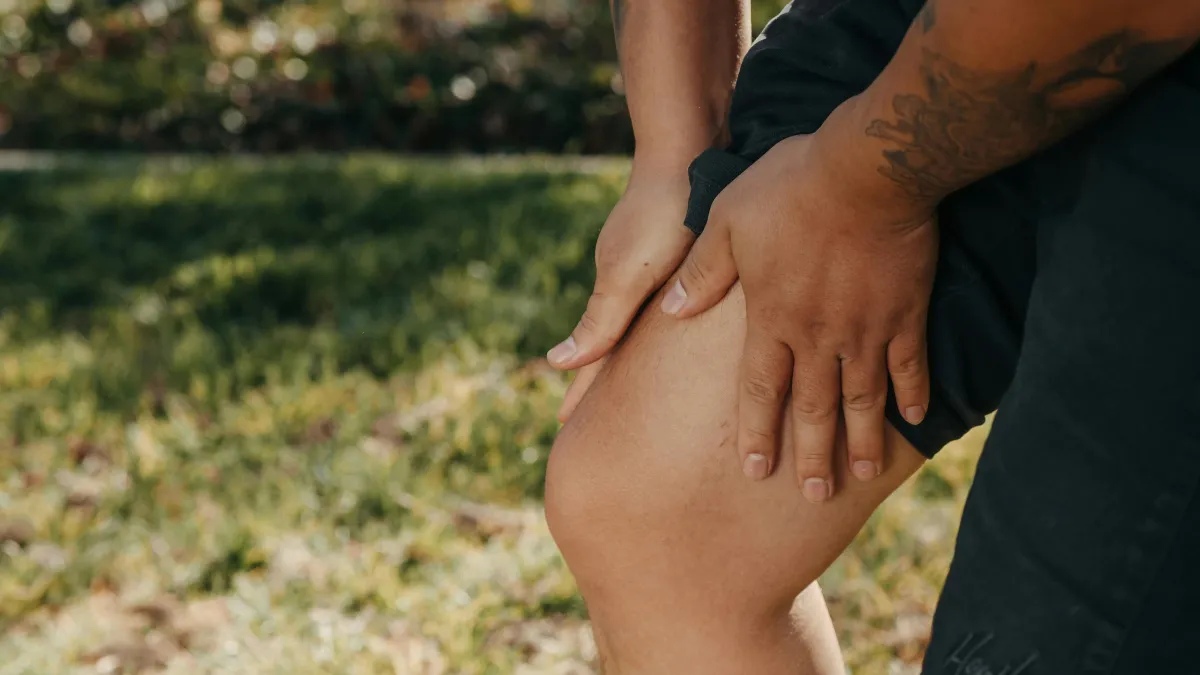 Man Holding His Knee