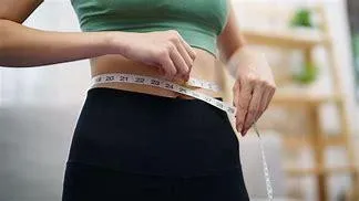 Woman Measuring Inches Around Stomach