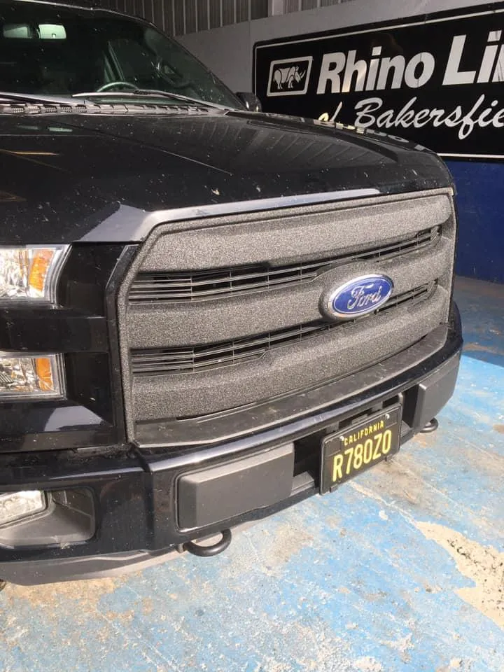 full grill of Ford sprayed black with a blue Ford badge