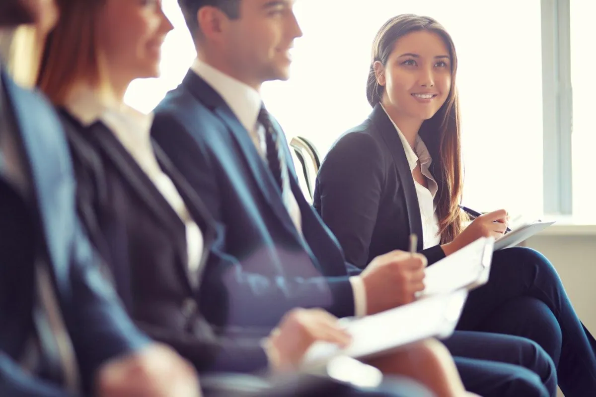 coworkers seated at the front at a convention - discipline