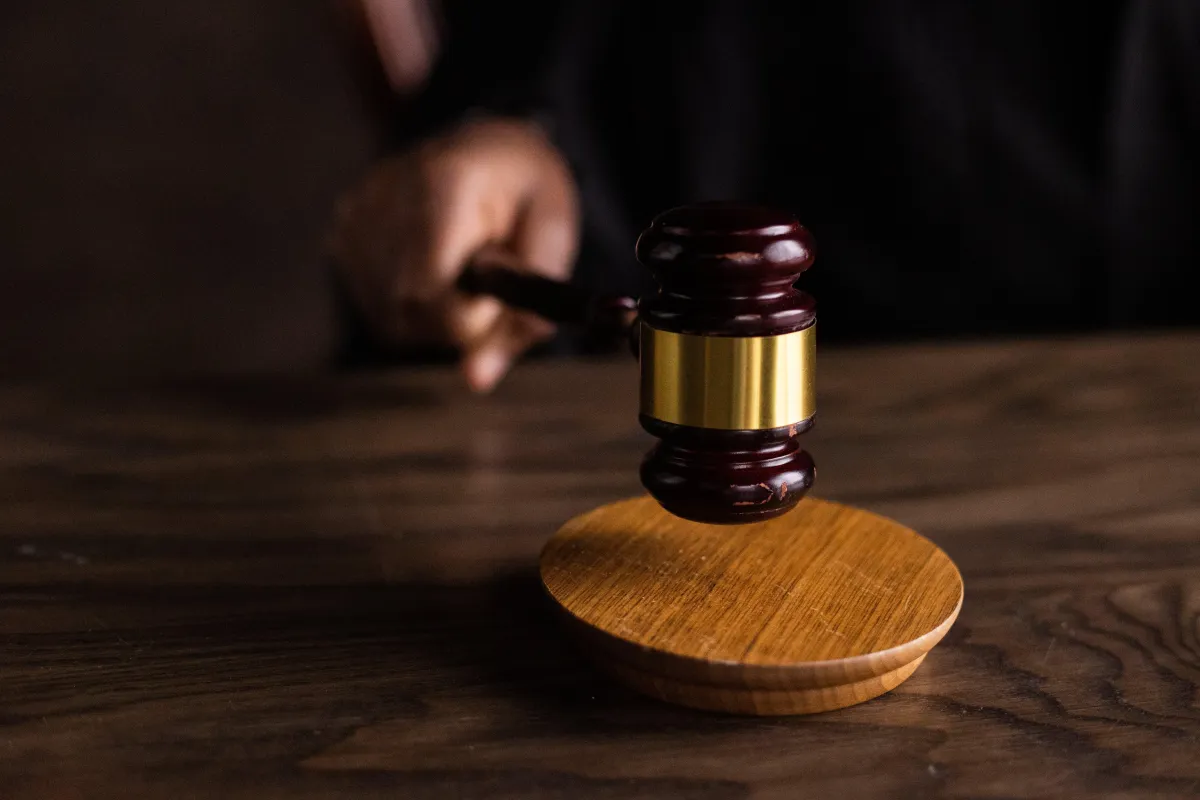 A judge's gavel resting on a wooden table, symbolizing authority and the power to make legal decisions.