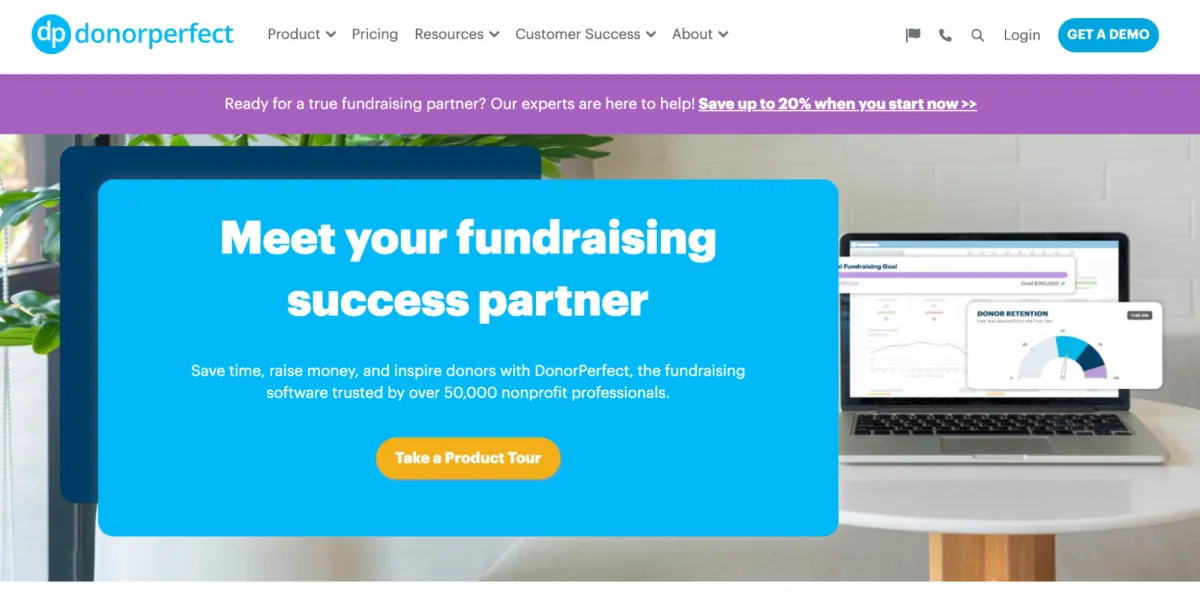 "DonorPerfect homepage featuring a bold blue banner with white text stating 'Meet your fundraising success partner.' Below, a subheading highlights DonorPerfect as trusted fundraising software for nonprofits. A call-to-action button labeled 'Take a Product Tour' is visible. In the background, a laptop displays fundraising analytics, including donor retention metrics.
