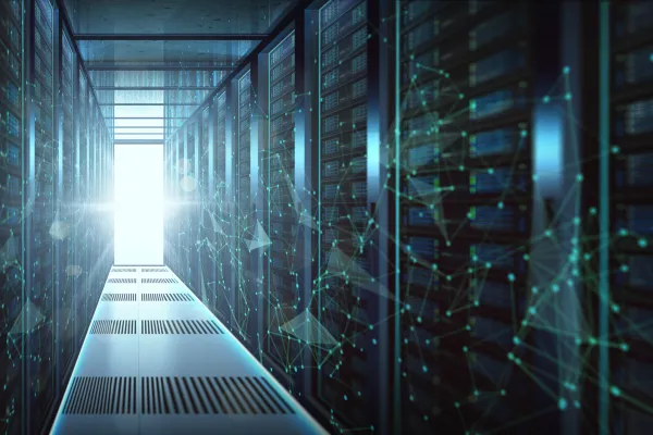 Interior of a modern data center with rows of server racks extending into the distance, illuminated by cool blue lighting and overlaid with digital network graphics, representing AI infrastructure and rising energy demand.