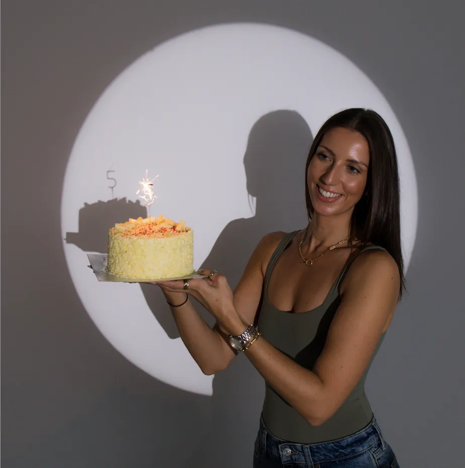 Nikki holding a cake with a 5 candle