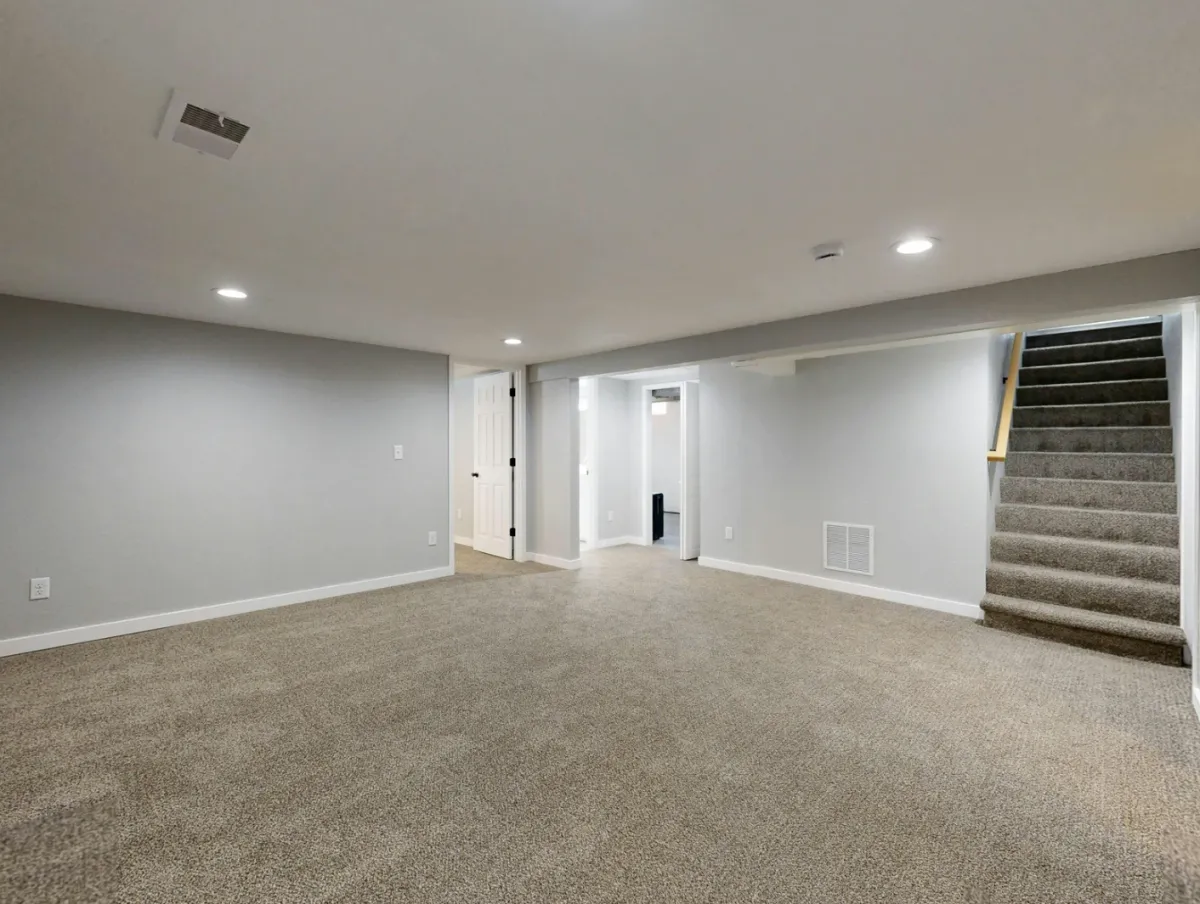 Finished basement in Charlotte featuring a bright living area and recessed lighting