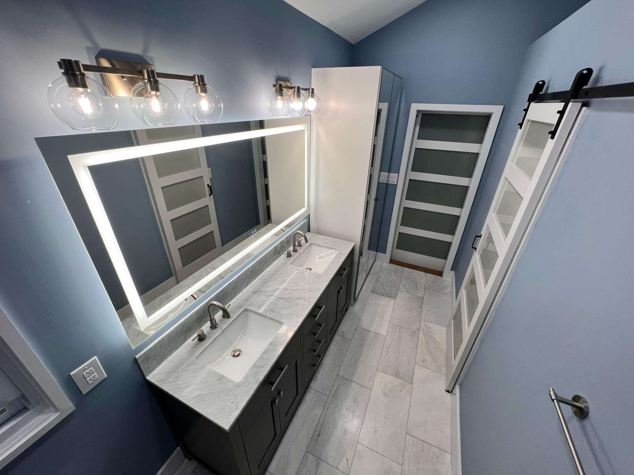 Master bathroom renovation in Pineville featuring brighter lighting and durable flooring