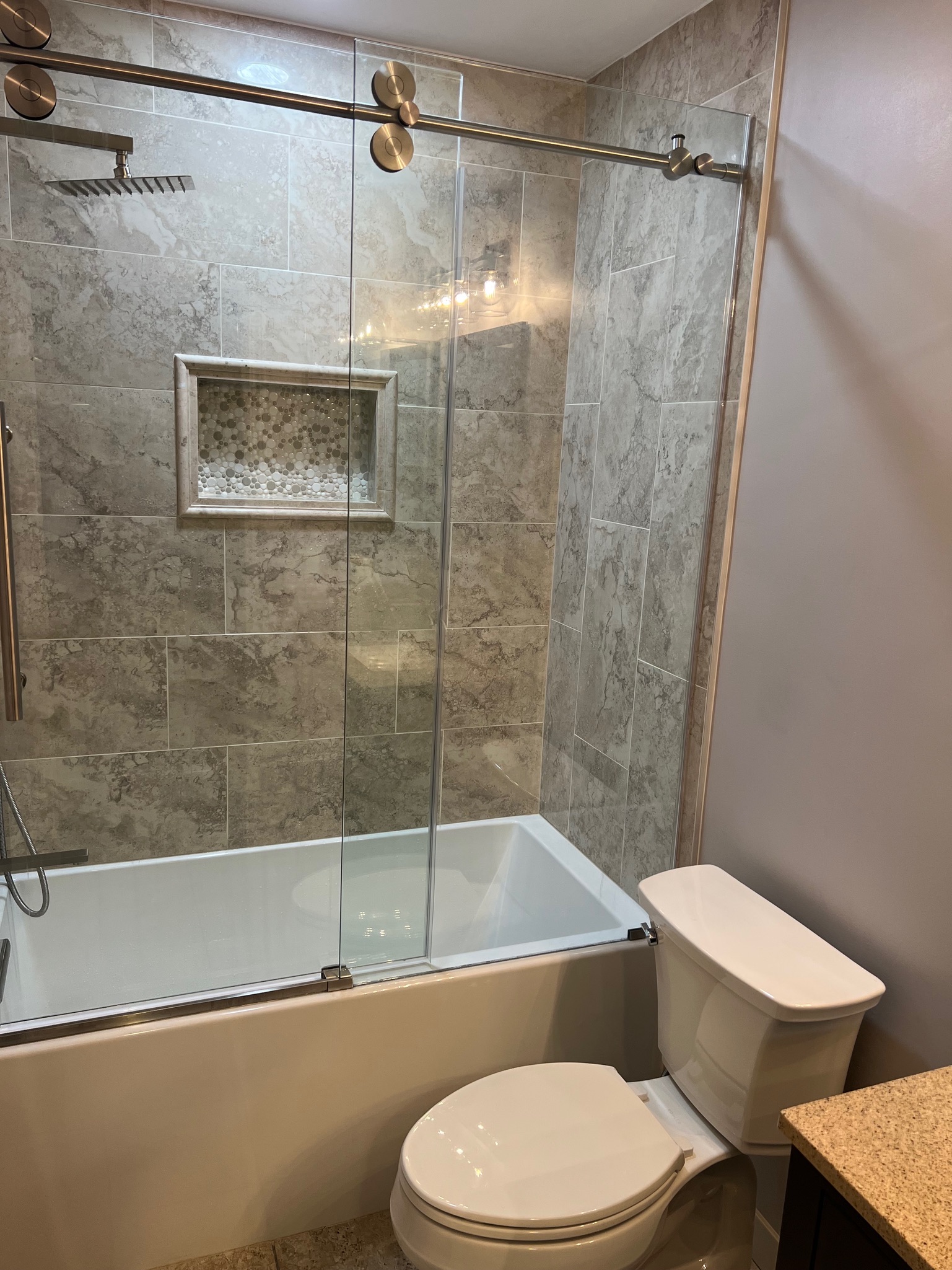 Master bathroom remodel in Charlotte featuring a custom tile shower and glass enclosure