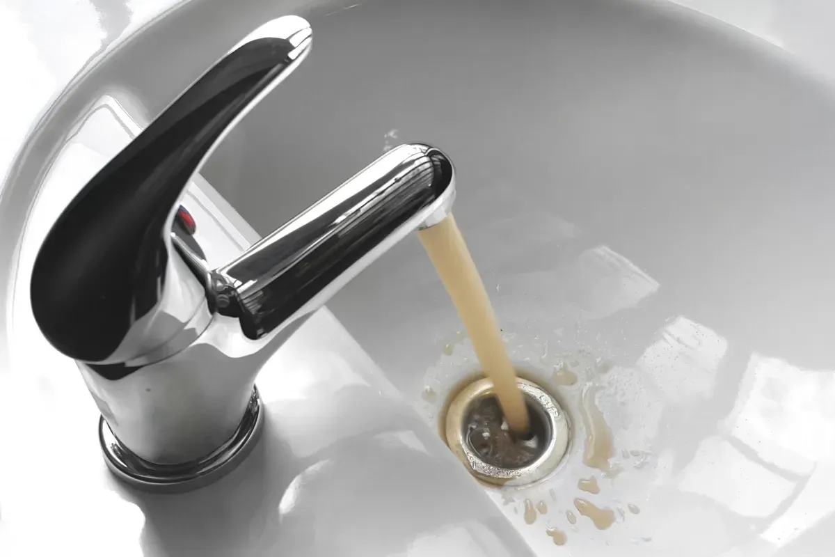 Brown water rushing out of a tap