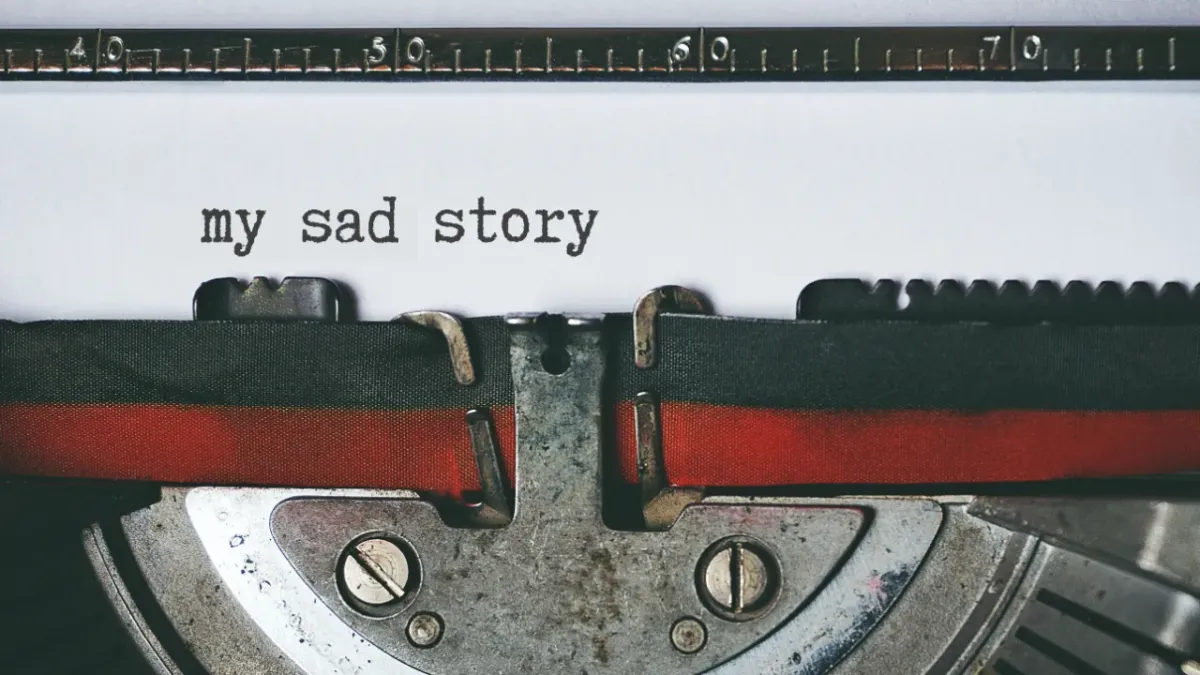 typewriter with the words "my sad story"